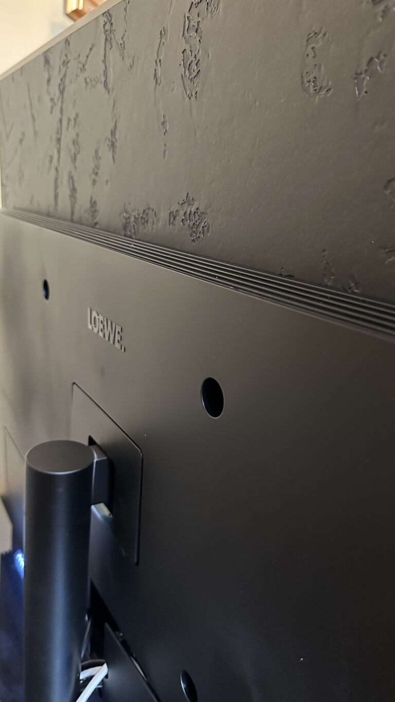 Loewe Stellar 48" OLED Smart TV With Wireless Loewe Subwoofer On A Table Stand