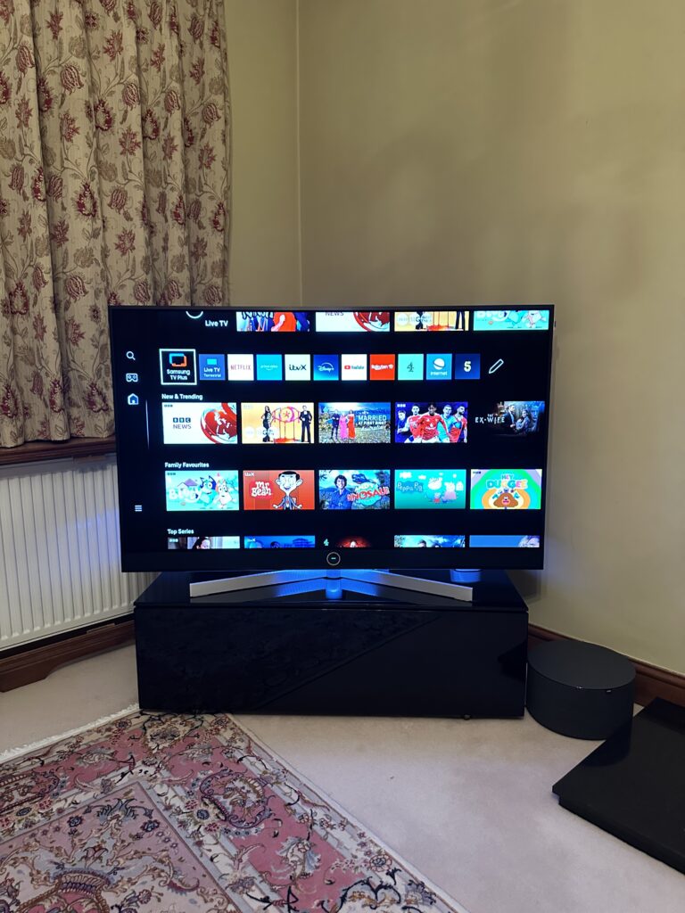 Loewe Stellar 48" OLED Smart TV With Wireless Loewe Subwoofer On A Table Stand