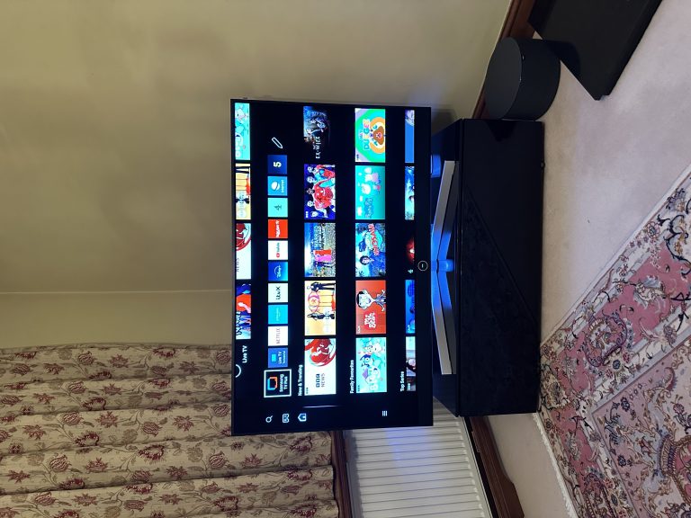 Loewe Stellar 48" OLED Smart TV With Wireless Loewe Subwoofer On A Table Stand